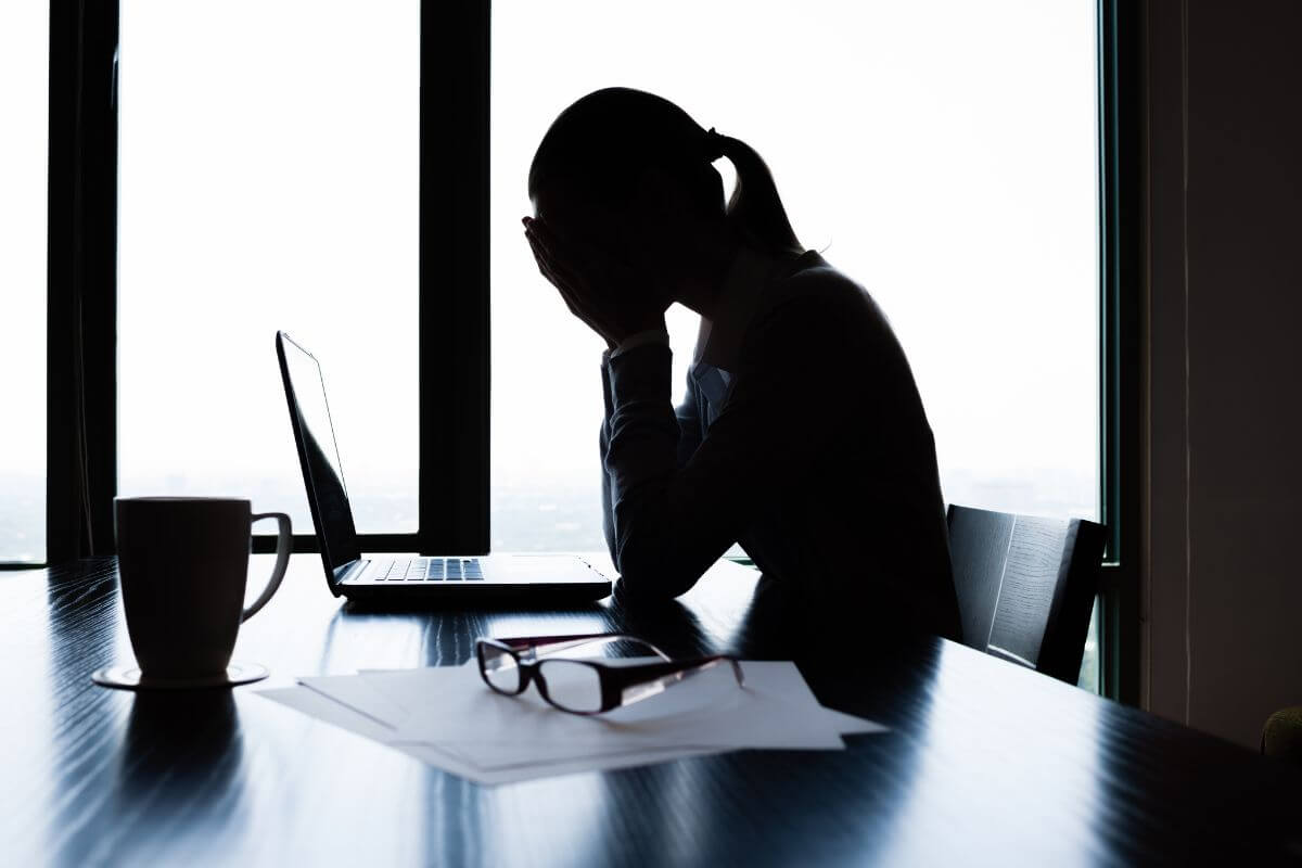 a girl sitting in front of a laptop