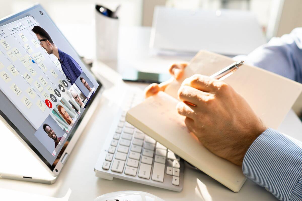 a person watching a video in a tablet holding a notebook