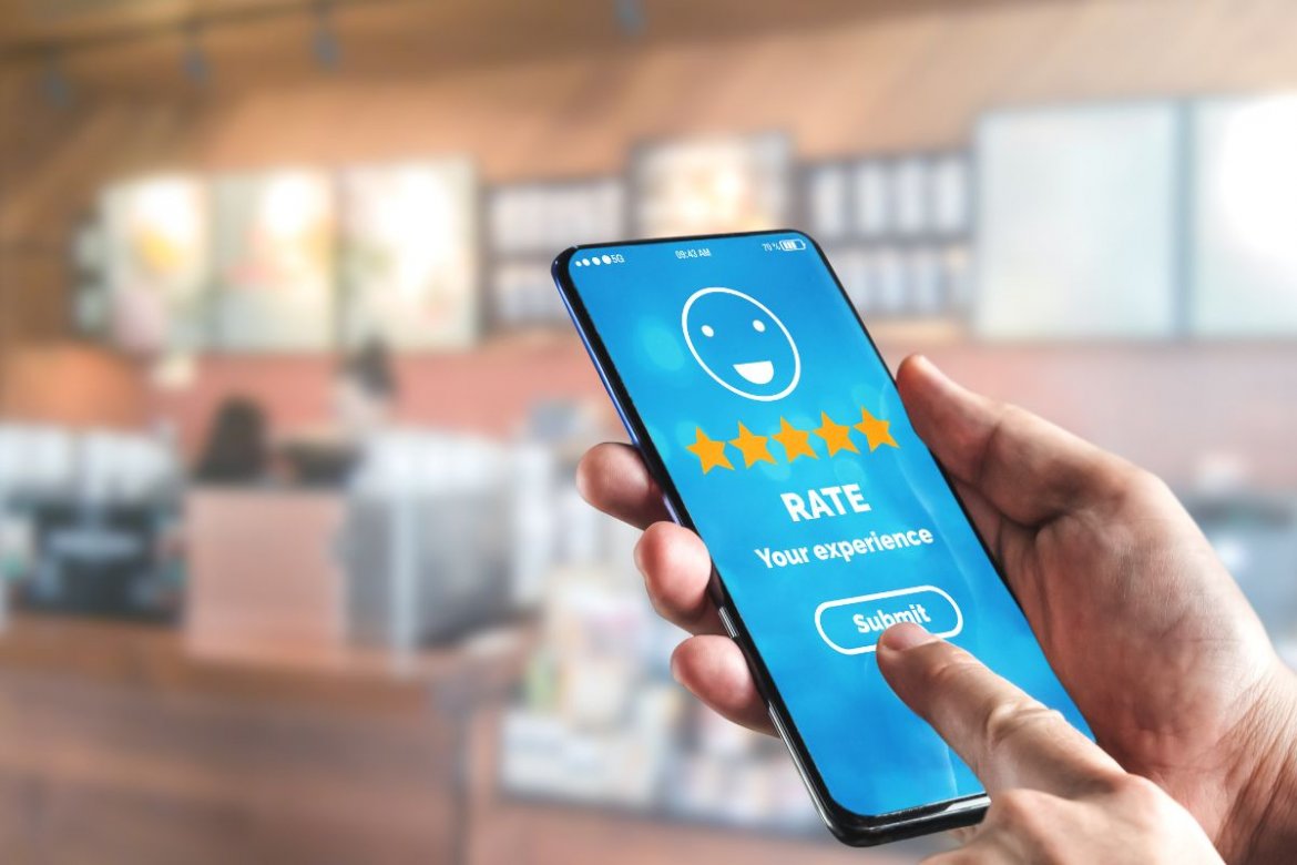 mobile phone showing a five star rating of service on the screen