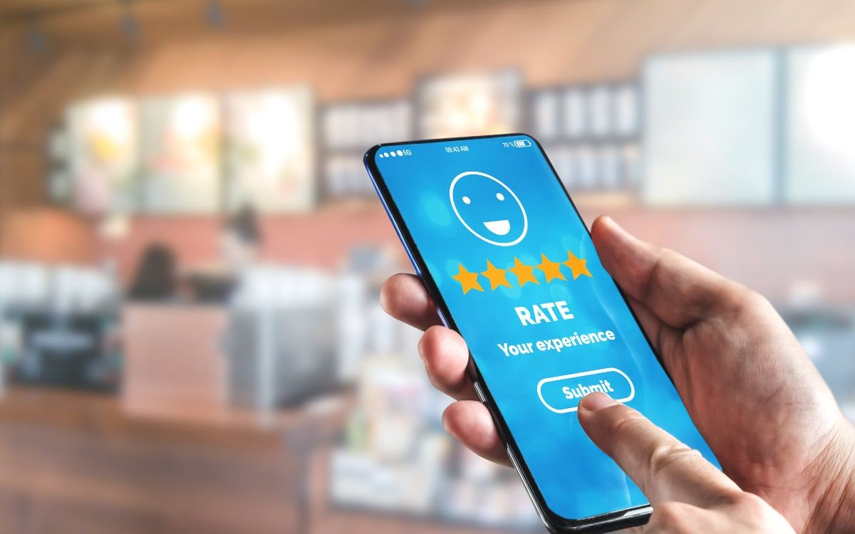 mobile phone showing a five star rating of service on the screen