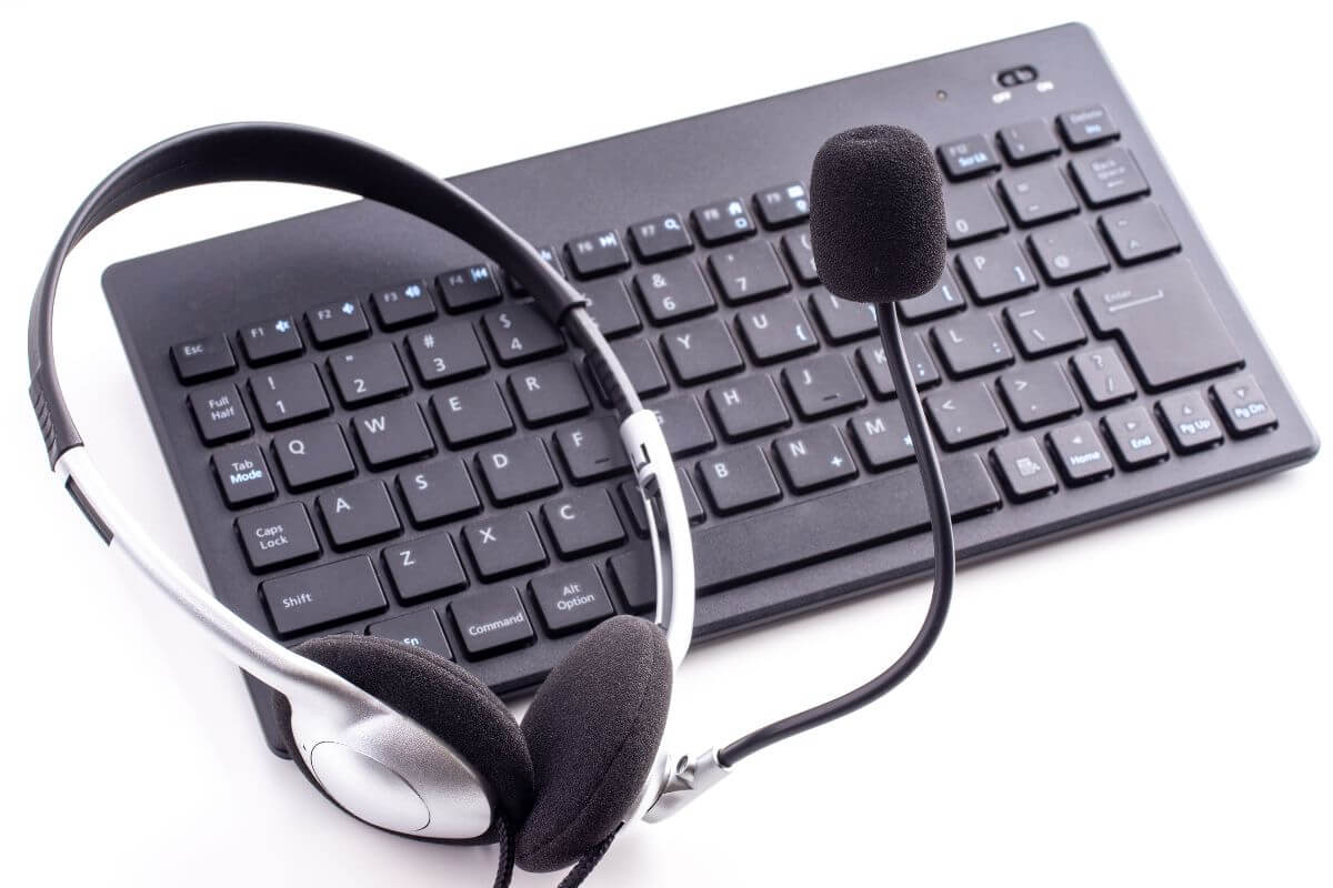 a call center headset on top of a keyboard