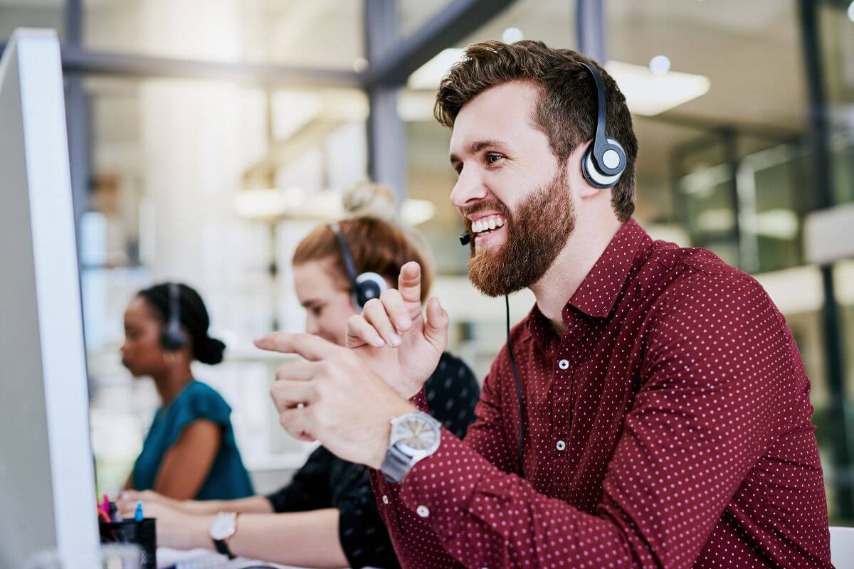 call center agent talking to customer in front of a computer