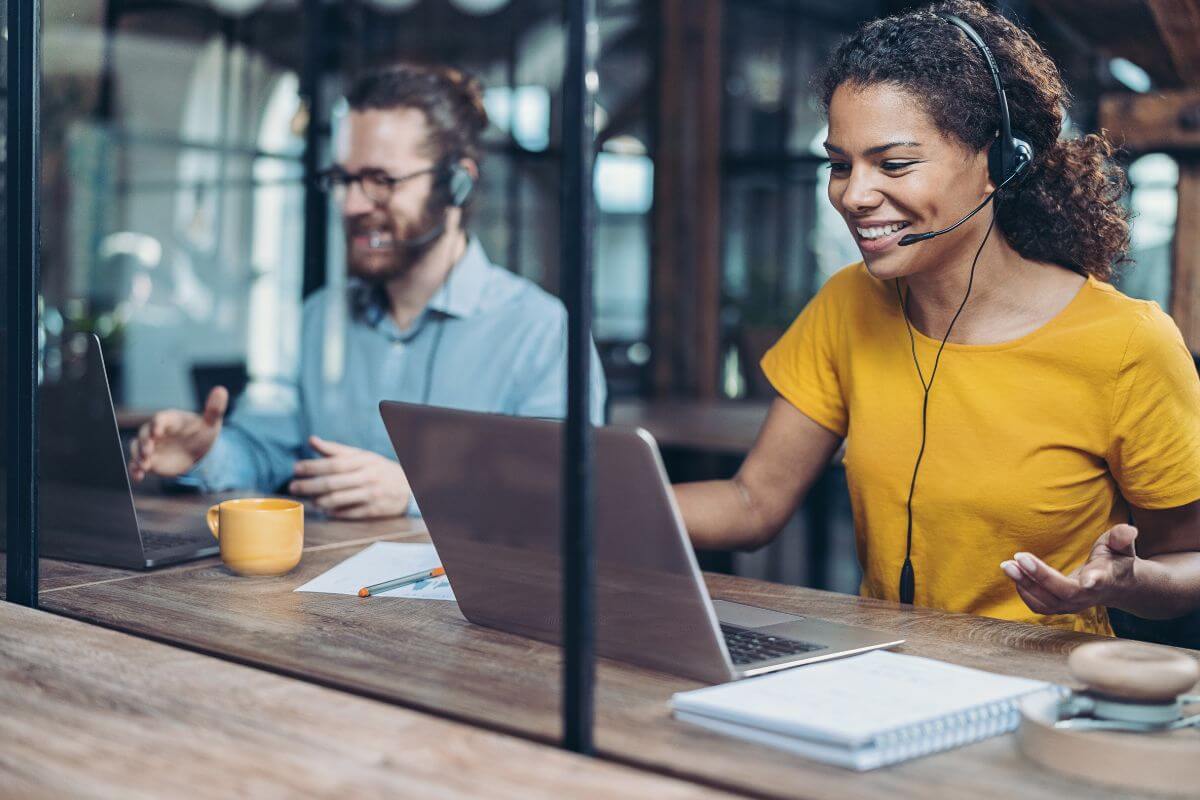 a man and a woman working as call center agents in an office